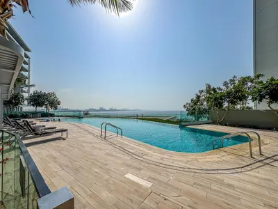 a swimming pool in the middle of a building at Mira Holiday Homes - Sky High Bliss at Bluewaters Residence 3 Ain View in Dubai