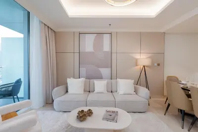 a living room with a couch and a table at Palace Beach Residence 2, Emaar Beachfront - Mint Stay in Dubai