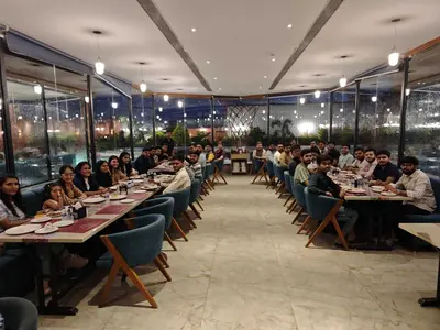 a group of people sitting at tables in a restaurant at A981 - kasturba Apt gandhi road in Dubai