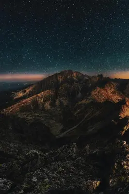 a night view of a mountain with a starry sky at A981 - kasturba Apt gandhi road in Dubai