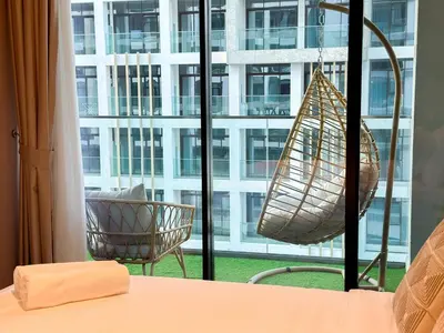 a room with a bed and a window with a building at Meydan Luxury Stylish 2BR with Pool & City Views in Dubai