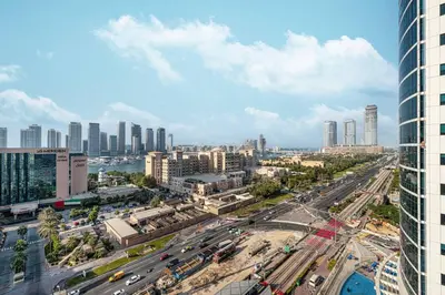 a city with a lot of traffic and buildings at StayMada - Ocean Heights Panoramic Beach Views in Dubai