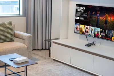 a living room with a couch and a tv at StayMada - Ocean Heights Panoramic Beach Views in Dubai