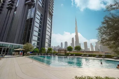 a large swimming pool in a city with tall buildings at VIDA DUBAI MALL - Burj Khalifa Views 2 Bedroom Apartment Opposite Dubai Mall & 5 Minutes Walk To Burj Khalifa and Dubai Fountain by NAMUVE in Dubai