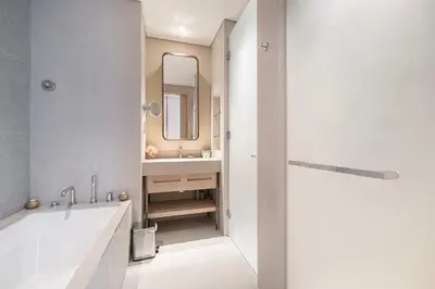 a bathroom with a tub and a sink and a mirror at VIDA DUBAI MALL - Burj Khalifa Views 2 Bedroom Apartment Opposite Dubai Mall & 5 Minutes Walk To Burj Khalifa and Dubai Fountain by NAMUVE in Dubai