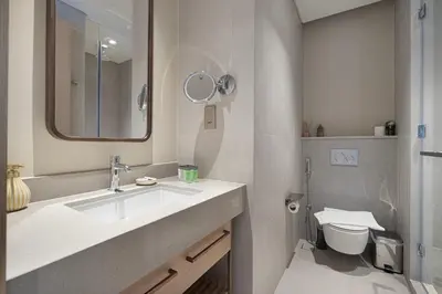 a bathroom with a sink and a toilet at VIDA DUBAI MALL - Burj Khalifa Views 2 Bedroom Apartment Opposite Dubai Mall & 5 Minutes Walk To Burj Khalifa and Dubai Fountain by NAMUVE in Dubai