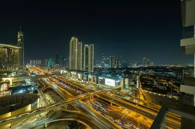 a busy city at night with traffic on the freeway at VIDA DUBAI MALL - Burj Khalifa Views 2 Bedroom Apartment Opposite Dubai Mall & 5 Minutes Walk To Burj Khalifa and Dubai Fountain by NAMUVE in Dubai