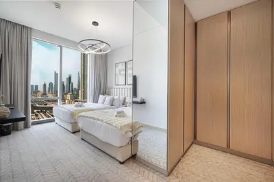 a bedroom with a bed and a large window at VIDA DUBAI MALL - Burj Khalifa Views 2 Bedroom Apartment Opposite Dubai Mall & 5 Minutes Walk To Burj Khalifa and Dubai Fountain by NAMUVE in Dubai