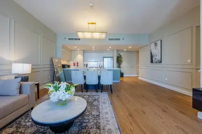 a living room with a couch and a table at Locations I Downtown Dubai I Premium 3BR Apartment I Luxury & Modern Interiors I Stunning Burj Khalifa Views I Steps from Dubai Mall & Dubai Fountain in Dubai