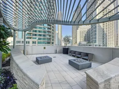a rooftop patio with a view of a city at Locations I Downtown Dubai I Premium 3BR Apartment I Luxury & Modern Interiors I Stunning Burj Khalifa Views I Steps from Dubai Mall & Dubai Fountain in Dubai