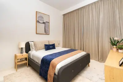 a bedroom with a bed in a room with a window at CitiHome - Elie Saab Luxury 2BR - Sea View in Dubai