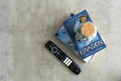 a remote control and a bag of cereal and a cup of coffee at 1BR with Burj Khalifa view in Business Bay in Dubai