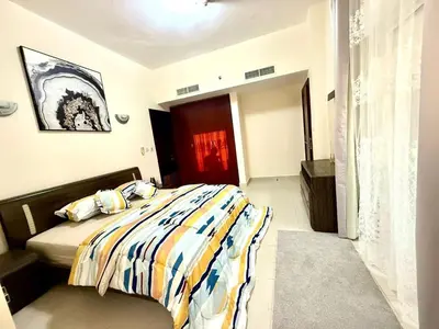 a bedroom with a bed and a red door at Dubai gate 1 in Dubai