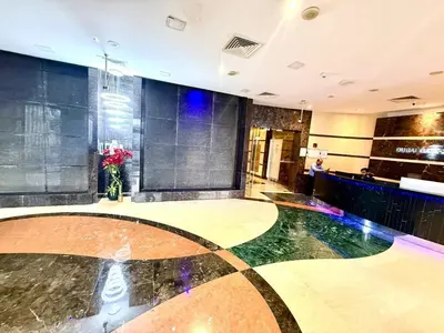 a lobby with an aquarium in the middle of a room at Dubai gate 1 in Dubai