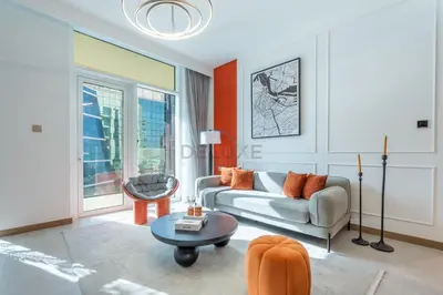 a living room with a couch and a table at Balcony with Panoramic Dubai Water Canal and City Views, Walking Distance to Metro and Marine Transport, Urban Oasis, Business Bay by Deluxe Holiday Homes in Dubai