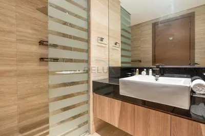 a bathroom with a white sink and a mirror at Balcony with Panoramic Dubai Water Canal and City Views, Walking Distance to Metro and Marine Transport, Urban Oasis, Business Bay by Deluxe Holiday Homes in Dubai