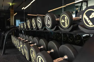 a row of dumbbells in a gym at Balcony with Panoramic Dubai Water Canal and City Views, Walking Distance to Metro and Marine Transport, Urban Oasis, Business Bay by Deluxe Holiday Homes in Dubai