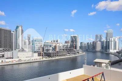 a view of a city with a river and buildings at Bloomfields Canal View 2Br Apt Canal Business in Dubai