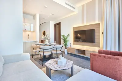 a living room with a couch and a tv at STAY BY LATINEM Luxury 1BR Holiday Home CC 2913 Near Burj Khalifa in Dubai