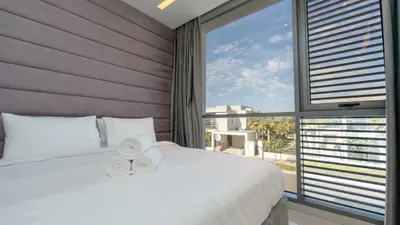 a bedroom with a large bed and a large window at Premium Sidra Villa with Private Pool and Exclusive Stay in Dubai