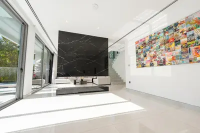 a living room with a large painting on the wall at Premium Sidra Villa with Private Pool and Exclusive Stay in Dubai