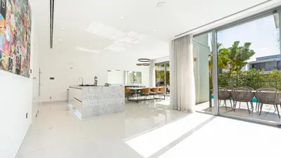 an open kitchen and dining room with sliding glass doors at Premium Sidra Villa with Private Pool and Exclusive Stay in Dubai