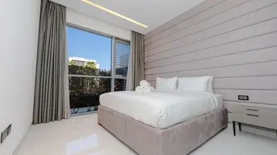 a bedroom with a large bed and a large window at Premium Sidra Villa with Private Pool and Exclusive Stay in Dubai