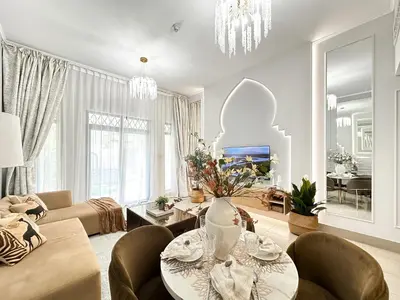 a living room with a couch and a table and chairs at Arabian Nights Luxury Garden Suite in Dubai