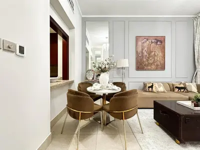 a living room with a table and chairs and a couch at Arabian Nights Luxury Garden Suite in Dubai