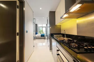 a kitchen with a stove and a sink at DAMAC MAISON PRIVE SLEEP FOUr in Dubai