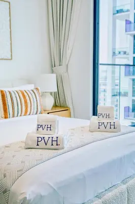 a bedroom with a bed with two pillows on it at PVH - Binghatti Lavender - Tranquil Modern 1BR - Near JVC Community Park in Dubai
