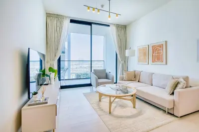 a living room with a couch and a table at PVH - Binghatti Lavender - Tranquil Modern 1BR - Near JVC Community Park in Dubai