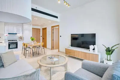a living room with a couch and a table at PVH - Binghatti Lavender - Tranquil Modern 1BR - Near JVC Community Park in Dubai