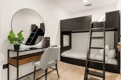 a bedroom with two bunk beds and a mirror at Stylish 2 Bedrooms, Pool, Gym & Family-Friendly in Dubai