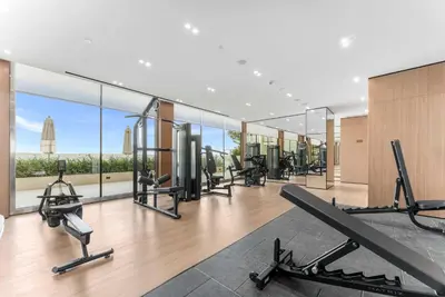 a gym with treadmills and cardio equipment in a building at Brand New Luxury Studio, Amazing Pool & Gym in Dubai