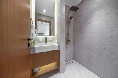 a bathroom with a sink and a mirror at Brand New Luxury Studio, Amazing Pool & Gym in Dubai