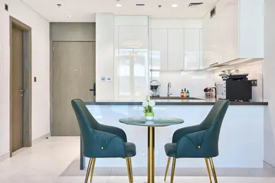 a kitchen with a table and two chairs at Newly Furnished Apt in District 1 in Dubai