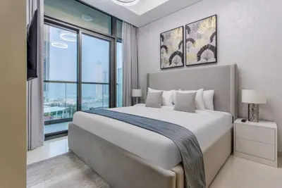 a bedroom with a large bed and a large window at Modern Luxury Stylish 2BR Near Downtown in Dubai