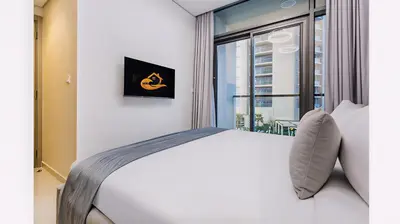 a bedroom with a large bed with a window at Modern Luxury Stylish 2BR Near Downtown in Dubai