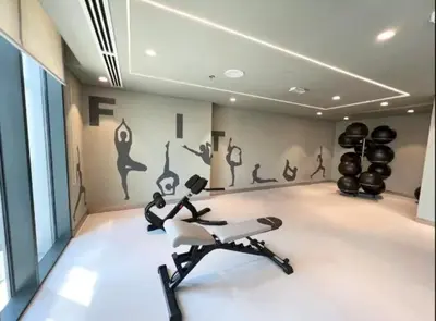 a room with a gym with a treadmill and exercise equipment at Luxury 2BR unit with speculator full road view in Dubai