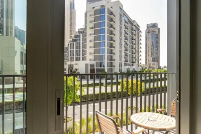 a balcony with a table and chairs and a view of a city at Luxury 2BR unit with speculator full road view in Dubai
