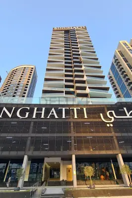 a tall building with a sign on it at Spacious Balcony Overlooking the Burj Khalifa and City Skyline, Near Bus Station, Quick Drive from Downtown Top Attractions, Binghatti Canal, Business Bay by Deluxe Holiday Homes in Dubai