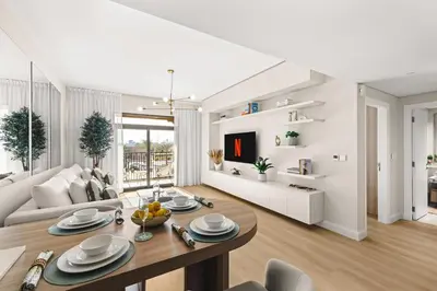 a living room with a dining table and a couch at Modern and family friendly 1 bed in Dubai