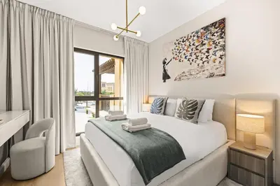 a bedroom with a large bed and a window at Modern and family friendly 1 bed in Dubai