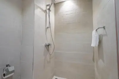 a bathroom with a shower and a toilet at GuestReady - Sunny Retreat near Dubai Frame in Dubai