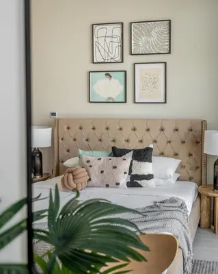 a bedroom with a bed with pillows and a plant at GuestReady - Sunny Retreat near Dubai Frame in Dubai