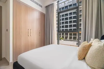 a bedroom with a white bed and a window at GuestReady - Contemporary elegance in Dubai in Dubai