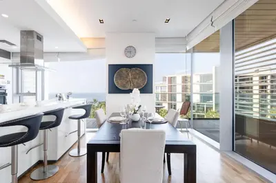 a kitchen and dining room with a table and chairs at Bluewaters 2B Iconic Ain Dubai and Sea View in Dubai