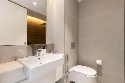 a white bathroom with a sink and a toilet at Bluewaters 2B Iconic Ain Dubai and Sea View in Dubai