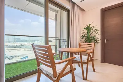 a dining room with a table and two chairs and a window at STAY BY LATINEM Luxury 1BR Holiday Home CVG 604 Near Downtown in Dubai